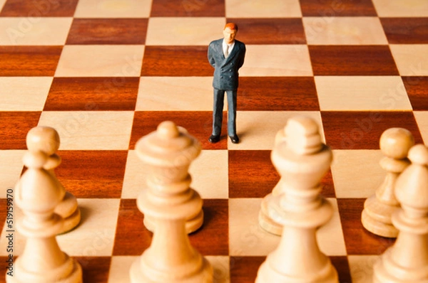 Fototapeta businessman miniature figurine on a chessboard, strategy and marketing decisions