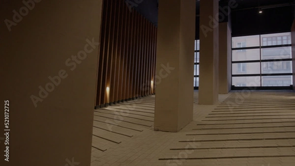 Fototapeta A bright corridor.Stock footage.Large columns and windows in the office building.