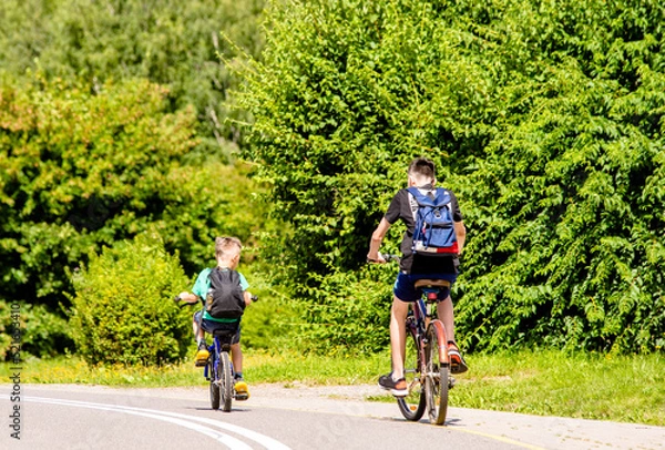 Fototapeta Cyclists ride on the bike path in the city Park
