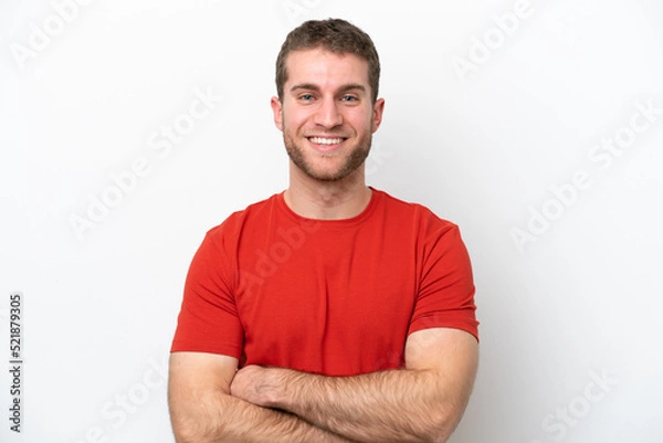 Fototapeta Young caucasian man isolated on white background keeping the arms crossed in frontal position