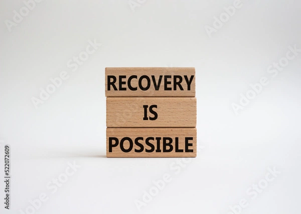 Fototapeta Recovery is possible symbol. Concept words Recovery is possible on wooden blocks. Beautiful white background. Business and Recovery is possible concept. Copy space.