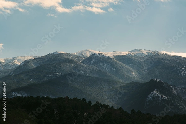 Obraz Landscape of Mount Ida with snow and some pine trees on the foreground.