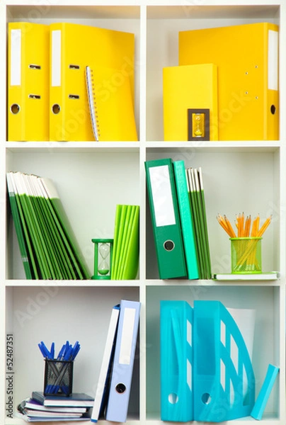 Fototapeta White office shelves with different stationery, close up