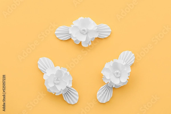 Fototapeta Paper flowers with leaves on yellow background