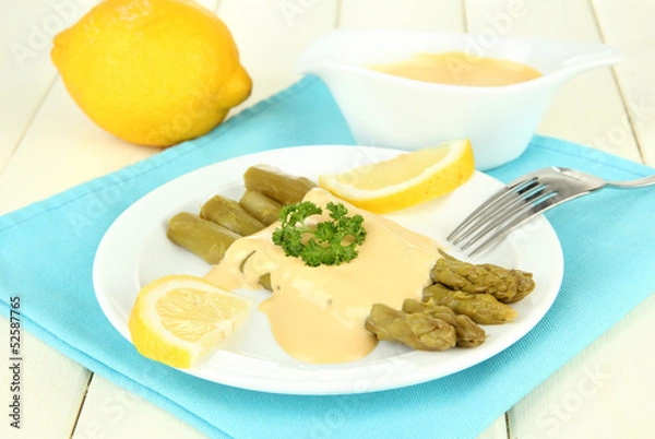 Fototapeta Asparagus on plate, on wooden background