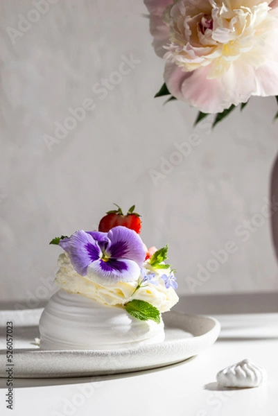 Fototapeta Sweet dessert Anna Pavlova decorated with flowers