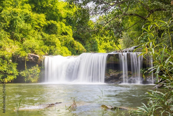 Fototapeta Waterfall in the deep forest. River stream waterfall in the forest landscape. Leaf moving low-speed shutter blur. Ubon Ratchathani, Thailand, Asia.