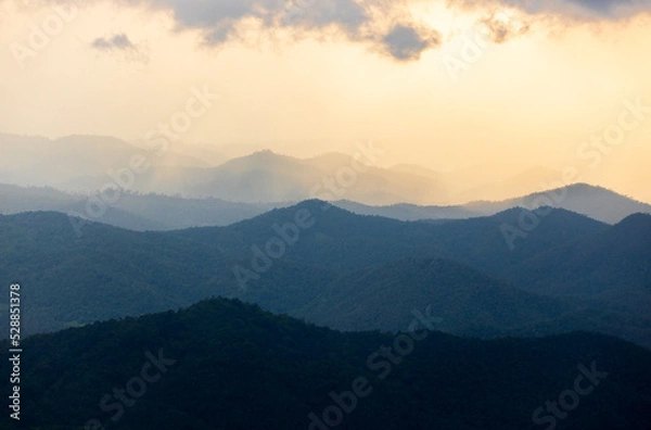 Fototapeta colorful dramatic sky with cloud at sunset. morning fog in dense tropical rainforest