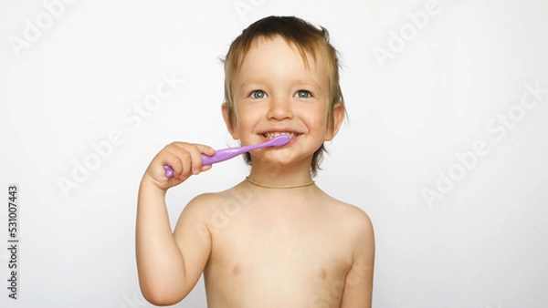 Fototapeta A cute boy has a fun brushing his teeth