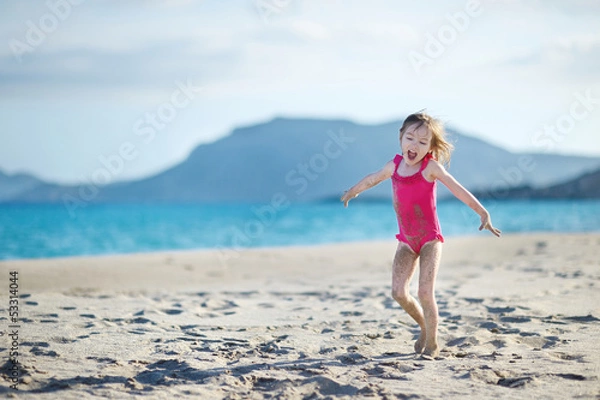 Fototapeta Adorable little girl on a sandy beach