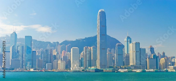 Fototapeta View of Victoria Harbor and Hong Kong skyline on a sunny day.