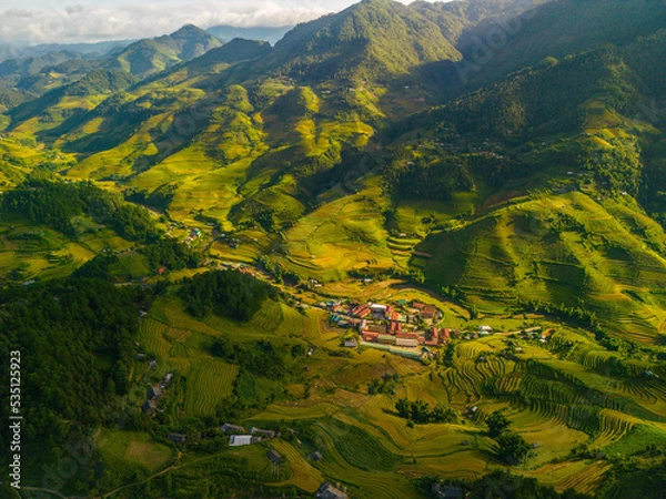 Fototapeta Aerial view of golden rice terraces at Mu cang chai town near Sapa city, north of Vietnam. Beautiful terraced rice field in harvest season in Yen Bai, Vietnam