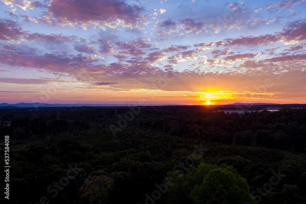 Fototapeta During beautiful purple sunset colorful sky is illuminated by luminous orange light