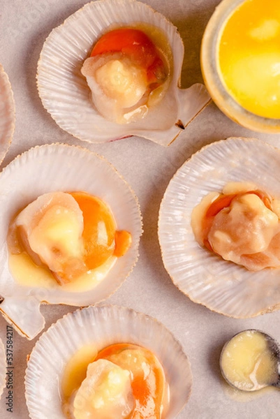 Fototapeta Raw scallops with melted butter