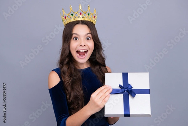 Fototapeta Child with gift present box on isolated background. Presents for birthday, Valentines day, New Year or Christmas. Excited teenager girl.