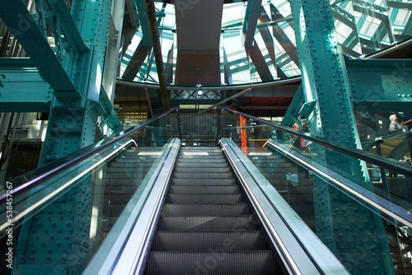 Fototapeta Escalator. View from below. Blue background. inside