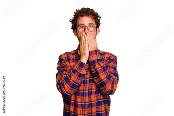 Fototapeta Young caucasian curly hair man isolated Young caucasian man with curly hair isolated shocked covering mouth with hands.