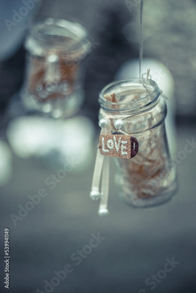 Fototapeta Wedding decorations Luxury original wedding floral decoration in the form of mini-vases and bouquets of flowers hanging from the ceiling.