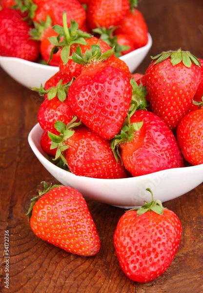 Fototapeta Fresh strawberry in bowl on wooden background