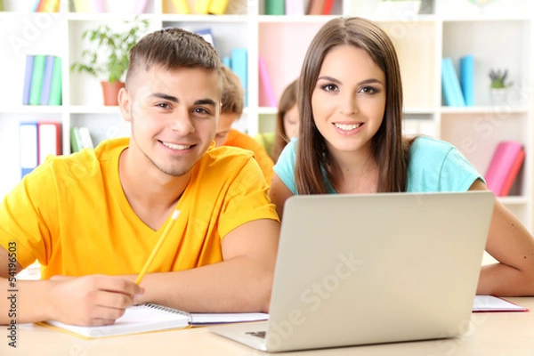 Fototapeta Group of young students sitting at the library