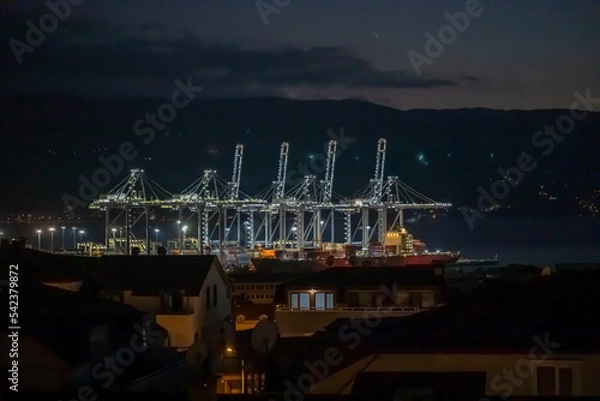 Fototapeta cranes in port loading containers on ships