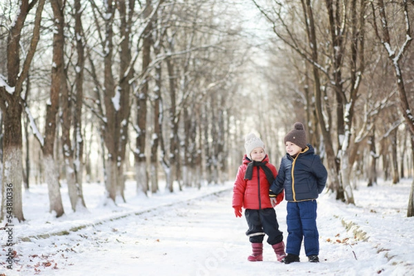 Fototapeta Children in winter park play