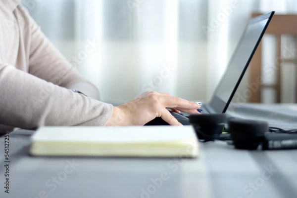 Fototapeta young woman's hand using computer with mouse working from home. selective focus