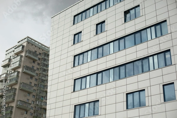 Fototapeta Building with windows in city. High house. Many floors in building. Modern architecture.