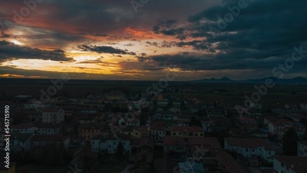 Fototapeta Aerial shot of the Bagnoli di Sopra commune in Italy, during an orange sunset