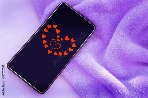 Fototapeta Smartphone screen with red hearts. Youth culture. Love, connection, dating  concept