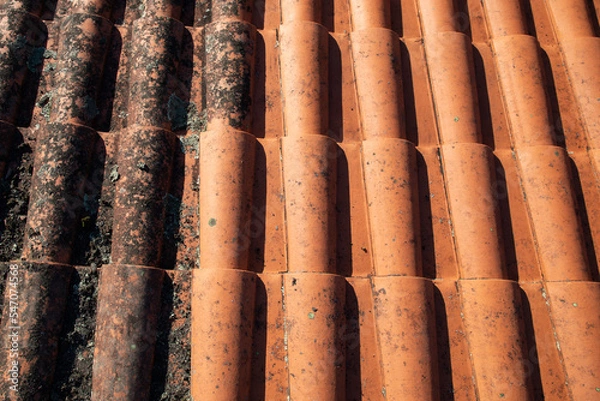 Fototapeta Dirty roof tiles with dirt moss requiring cleaning before and after