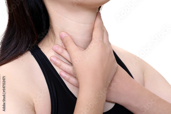 Fototapeta A woman suffering from esophagitis is touching her wrinkled neck.