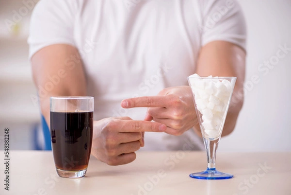 Fototapeta Young male student testing soft drink