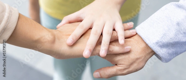 Fototapeta Header crop of Lovely Asian three generation family with grandfather and mother putting hand together, concept of strong family love and family togetherness