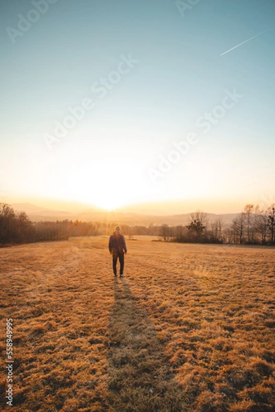 Fototapeta Adventurer in winter jacket enjoys the last touches of the sun. Sunset over stress-relief guy from work and get back positivity. Beskydy mountains, Czech republic