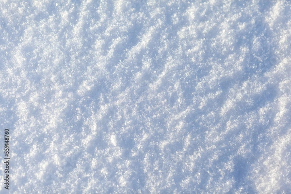 Fototapeta Clean, white snow close-up. Winter background. Snow surface. Fresh fluffy white snow texture.White snowflakes. High quality photo