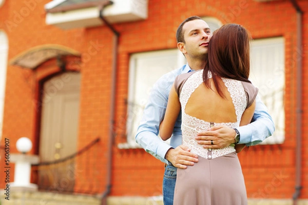 Fototapeta Happy couple standing in front of new home