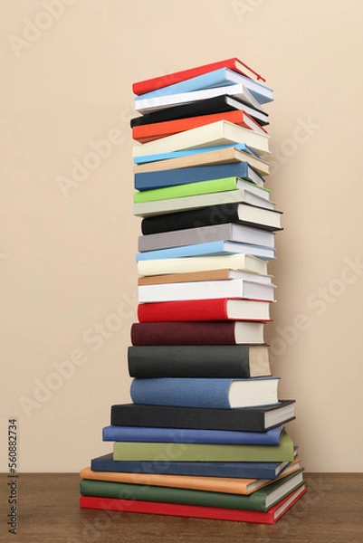 Fototapeta Stack of hardcover books on beige background