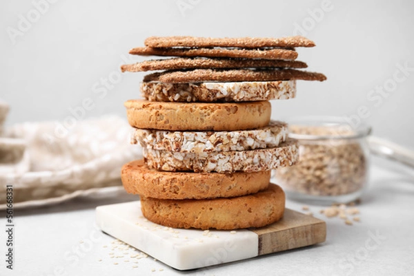 Fototapeta Stack of rye crispbreads, rice cakes and rusks on white table