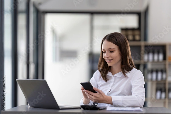 Fototapeta Business woman using smartphone for do math finance on wooden desk in office, tax, accounting, financial concept