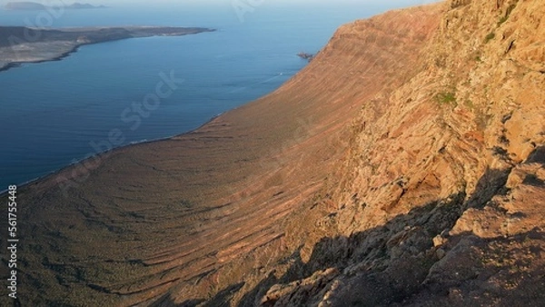 Fototapeta Spain, Lanzarote, Canary island - drone  aerial view  of Mirador del Rio coastline on the  Risco de Famara La gracious tourist attraction destination - Sunset and Travel in Lanzarote 