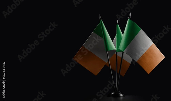 Fototapeta Small national flags of the Ireland on a black background