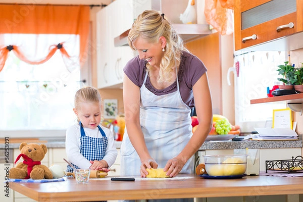 Fototapeta Mother and daughter baking cookies together