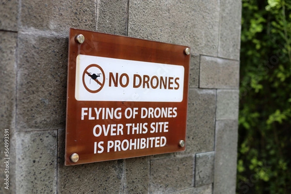 Fototapeta No drone zone sign not allowing flying of quad copter around tall building