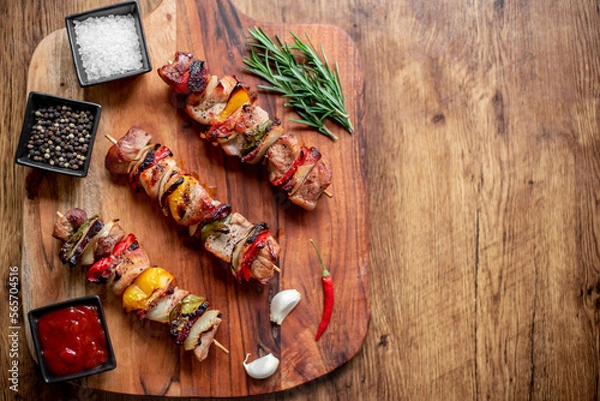 Fototapeta Meat kebabs with grilled vegetables on a rustic background