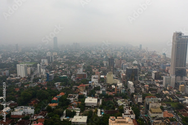 Fototapeta Aerial drone of city of Colombo with skyscrapers in the fog.