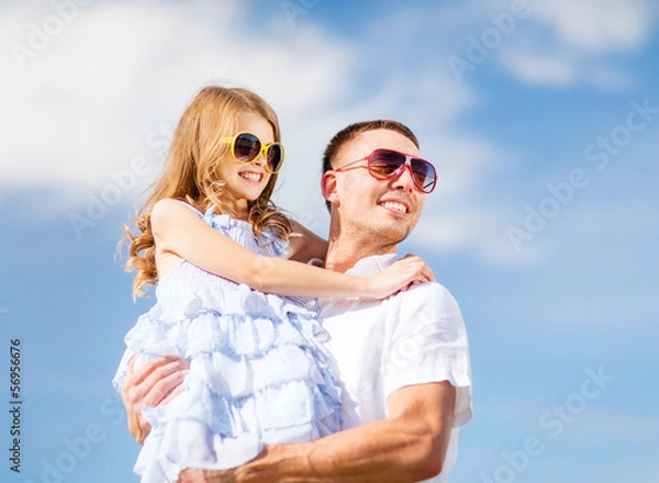 Fototapeta happy father and child in sunglasses over blue sky