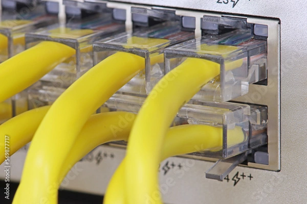 Fototapeta Connecting an Ethernet switch using patch cords with RJ45 connectors for data transmission in the data center.