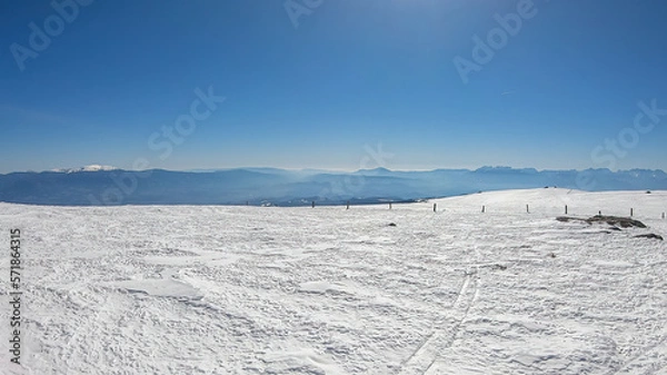 Fototapeta Scenic view of snow covered alpine meadows and Koralpe mountains seen from Ladinger Spitz, Saualpe, Lavanttal Alps, Carinthia, Austria, Europe. Untouched field of snow. Ski touring snowshoeing tourism