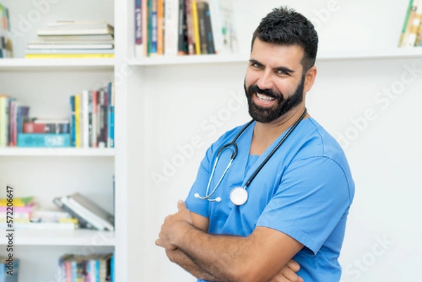 Fototapeta Laughing mexican mature male doctor or nurse